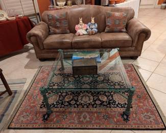 Leather couch, coffee table, area rug