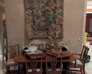 Dining table with chairs, area rug, wall tapestry art