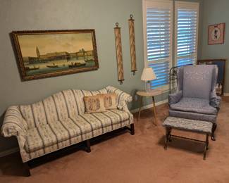 Sofa, wingback chair, stool, artwork