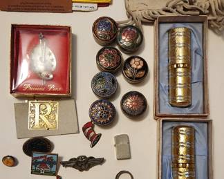 Lapel pins, metal pill cases, leather bag, lip stick 