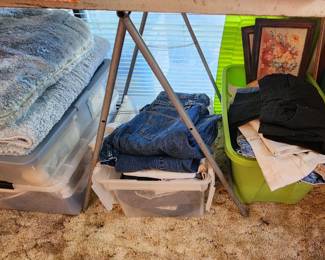 Storage bins with jeans, sweaters, shirts