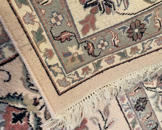 Back-side image of area rug (pale pink, gray, and white)