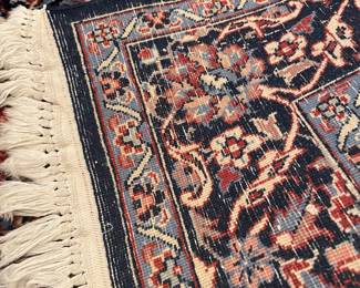 A view of the back of the Kashan style rug - 100% wool