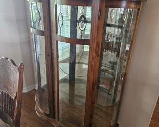 Antique solid wood curved curio. 44 in wide by 20 in deep and 64 in tall. One panel of glass is cracked as seen in photo. $500.00