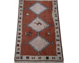 SOUTHWEST RUG | Three medallion rug with figures on a rust ground within a patterned border. - w. 36 x l. 63 in