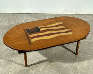 AMERICAN FLAG HEART PAINTED TABLE | Low oval top wood table with painted American flag with heart motif. - h. 16 x l. 47 x d. 24 in

