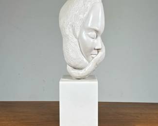 COMPOSITION SCULPTURE of a WOMAN | Resin or other, showing the face of a lady with sinuous hair, no apparent signature or identifying marks. - h. 15 x l. 6 x d. 4 in
