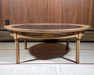 Round Mid-century Coffee Table | Low table with a black inset top in a wood frame. - h. 14.5 x dia. 40.75 in

