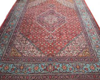 EARLY 20th CENTURY PERSIAN KASHAN CARPET | Central medallion on a red ground within blue and red borders. - w. 105 x l. 145 in