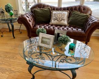 Tufted, leather loveseat. 37" x 49"  wrought iron, glass coffee table. Matching 32" round side table. Home decor