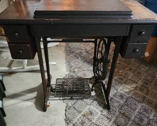 Old sewing cabinet, with sewing machine.