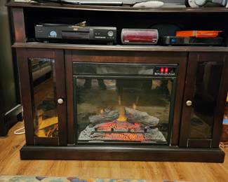 Nice electric fireplace with storage.