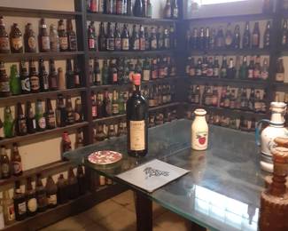 In basement---beer bottle collection, large gass bar table