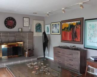 Another view of large coffee table, dresser and art work