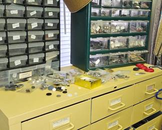 Metal cabinet full of organized buttons