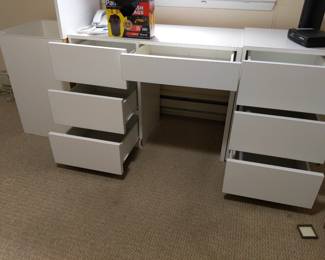 7 drawer desk next to a top-opening cabinet for larger items