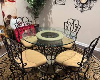 Kitchen table and chairs
4 Wrought Iron chairs glass top table and a wrought iron base.. Glass has some scratches..