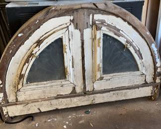 Vintage arched  double glass window opening up to metal grates