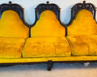 This antique hand carved L shaped sofa has 3 pieces.  There is a square hand carved table that joins the 2 sofas