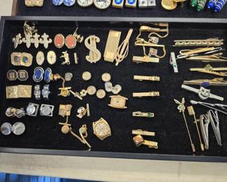 collection of tie clips and lapel pins and cufflinks 
