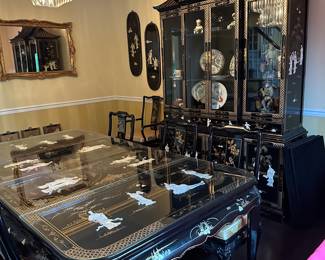 Black Lacquered & Handpainted Dining Table&nbsp;&nbsp;- Carved with Mother of Pearl Inlay - Fitted with glass top - there are 6 side chairs with upholstered cushions, 2 arm chairs with upholstered cushions and 2 table extensions&nbsp;- Black Lacquered & Handpainted Illuminated China Cabinet&nbsp;- Carved with Mother of Pearl Inlay;&nbsp;
