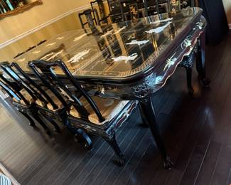 Black Lacquered & Handpainted Dining Table&nbsp;&nbsp;- Carved with Mother of Pearl Inlay - Fitted with glass top - there are 6 side chairs with upholstered cushions, 2 arm chairs with upholstered cushions and 2 table extensions&nbsp;