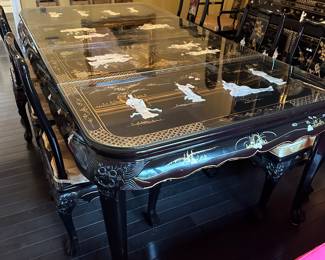 Black Lacquered & Handpainted Dining Table&nbsp;&nbsp;- Carved with Mother of Pearl Inlay - Fitted with glass top - there are 6 side chairs with upholstered cushions, 2 arm chairs with upholstered cushions and 2 table extensions&nbsp;