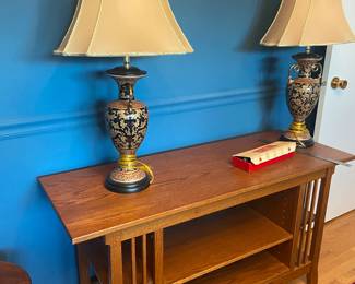 Wood mission entertainment center with matching lamps.