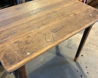 Wooden table with folding legs.