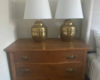 Antique three-drawer oak chest and a pair of vintage brass table lamps.