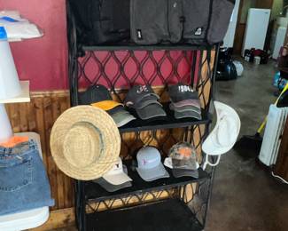 Tall iron rack loaded w/ caps, hats & luggage