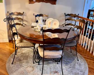 53" Round kitchen table w/wrought iron legs and a glass top - 6 Chairs, sold separately 