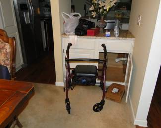 A rolling walker and an open cupboard.  Because yes, it would have been too much like work to close the cupboard door