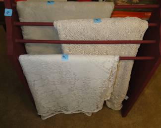 A quilt rack that is holding tablecloths.  The set up team is simply rebellious!!!