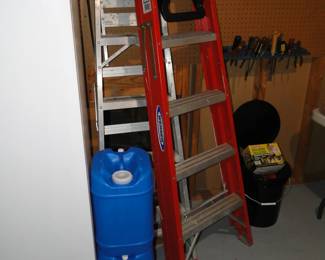 Blue water jugs, for holding water that is potable, and a small ladder, and a larger ladder too.  Jusat so you know, the water jugs have never been used at all