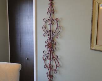 Large ornate solid metal wall art.  You can hang it up and down like you see, or you can hand it sideways too, so it can fit over a door.  But, if you put it over a door, make sure it is secure.  Because nothing says.."Welcome to my home" than a solid metal piece of art crashing down on your friends head.  So make sure it is secure