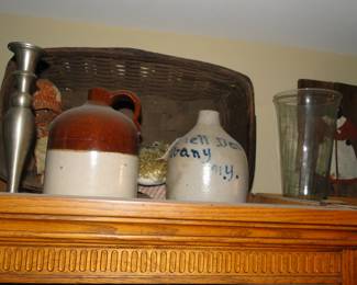 From left to right, a large pewter candlestick, a jug of some sort, and a classic salt jug from Albany New York
