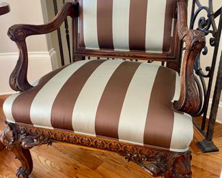 Transitional Louis XV/XVI-Style Fauteuil with a padded rectangular back surmounted by a foliate, joined by out-scrolled arms to the padded seat, raised on cabriole legs ending in scrolled toes.