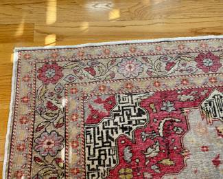 Persian Rug 48 x 72 - Handcrafted by skilled artisans, each rug tells a unique story through its intricate patterns and vibrant colors, seamlessly blending luxury with functionality.  Large central medallion with floral patterns containing rich reds, light blues, golds, and ivory.