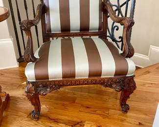 Transitional Louis XV/XVI-Style Fauteuil with a padded rectangular back surmounted by a foliate, joined by out-scrolled arms to the padded seat, raised on cabriole legs ending in scrolled toes.