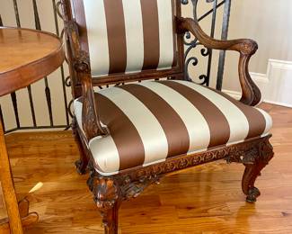 Transitional Louis XV/XVI-Style Fauteuil with a padded rectangular back surmounted by a foliate, joined by out-scrolled arms to the padded seat, raised on cabriole legs ending in scrolled toes.