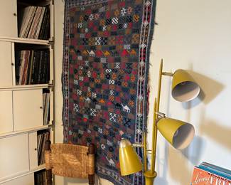 Yellow atomic floor lamp, Middle East wool wall hanging with camel design, one of a pair of American craftsman made chairs