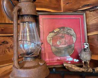 antique kerosene lantern, framed service station cap, quail taxidermy