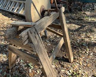 antique grindstone sharpener on wooden stand