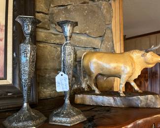 candlesticks and carved bull statue