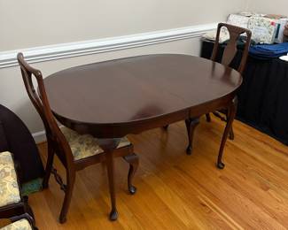 C1 - $495. Craftique Solid Wood Table. Measures 56" long x 42" wide x 30" tall. Has table pad & 3 leaves that add 12" each. Includes 1 arm chair 5 regular chairs. Very sturdy and in good condition 