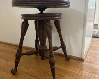 C12 - $50 - Antique Piano Stool with Glass feet. Seat is 14" round - height is adjustable. 
