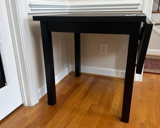 C8 - $85 - Ikea Nordviken Drop Leaf Table in Black. (Needs piece installed to hold open drop leaf) Measures 29" square x 29.5" tall. Leaf adds 12". 