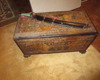Antique carved trunk with sword