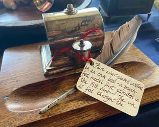Antique inkwell with stand and quill